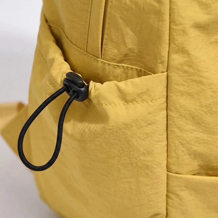 Unisex laptop backpack, minimalist design, water-resistant nylon, perfect for daily essentials & urban travel.