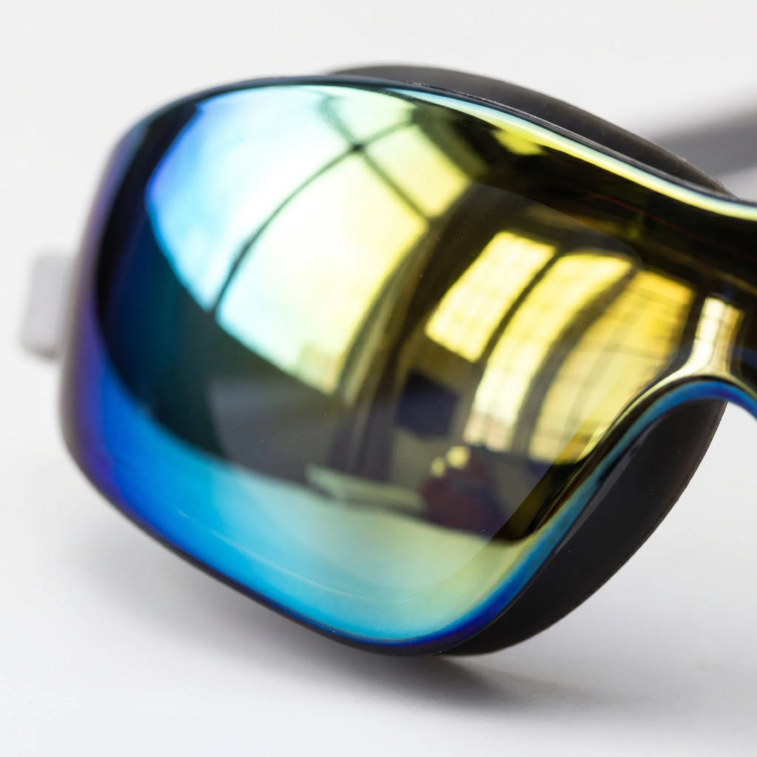 Close-up of sleek unisex mirrored swimming goggles, ideal for athletes seeking clear vision, UV protection, & comfortable fit.