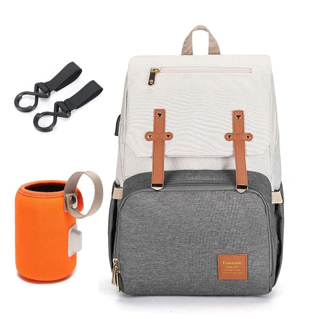 Interior view of a spacious unisex diaper backpack, showing insulated pockets and baby organization compartments.