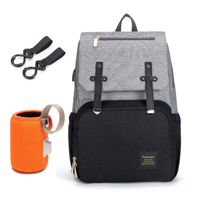 Unisex maternity backpack attached to a baby stroller, highlighting its multi-functional use for new parents.