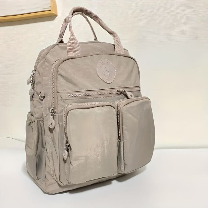 Stylish unisex multi-pocket backpack, weather-resistant & comfortable for daily carry & travel.
