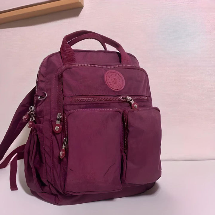 Organized multi-pocket travel backpack, unisex design for efficient storage of daily essentials.