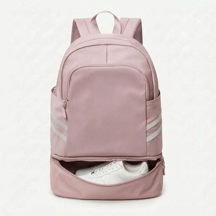 Person wearing a sleek unisex sports backpack. Multi-pocket design for gym, work, or weekend travel.