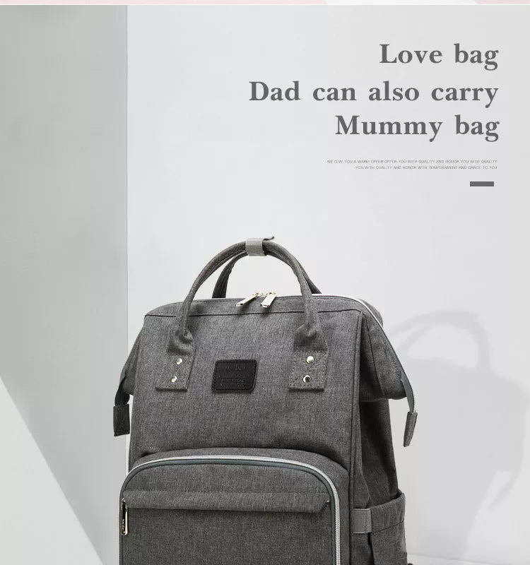 Unisex nappy backpack featuring sturdy grab handle for easy carrying