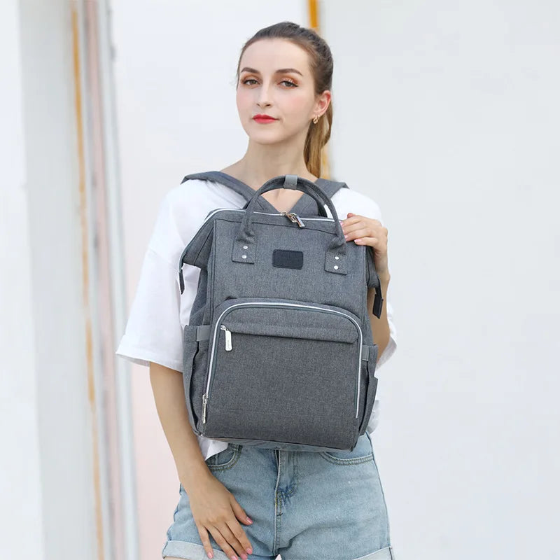 Open view of unisex nappy backpack compartments, organized storage for baby supplies