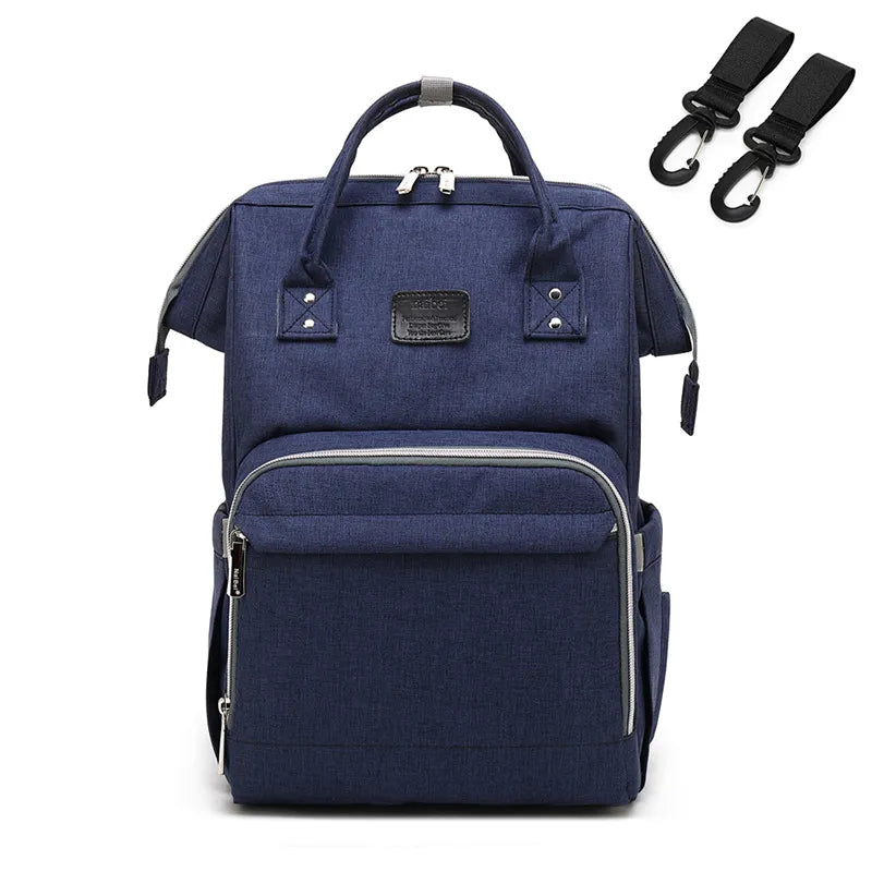 Baby changing mat integrated into a unisex nappy backpack, convenient for travel