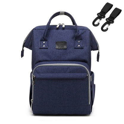 Baby changing mat integrated into a unisex nappy backpack, convenient for travel