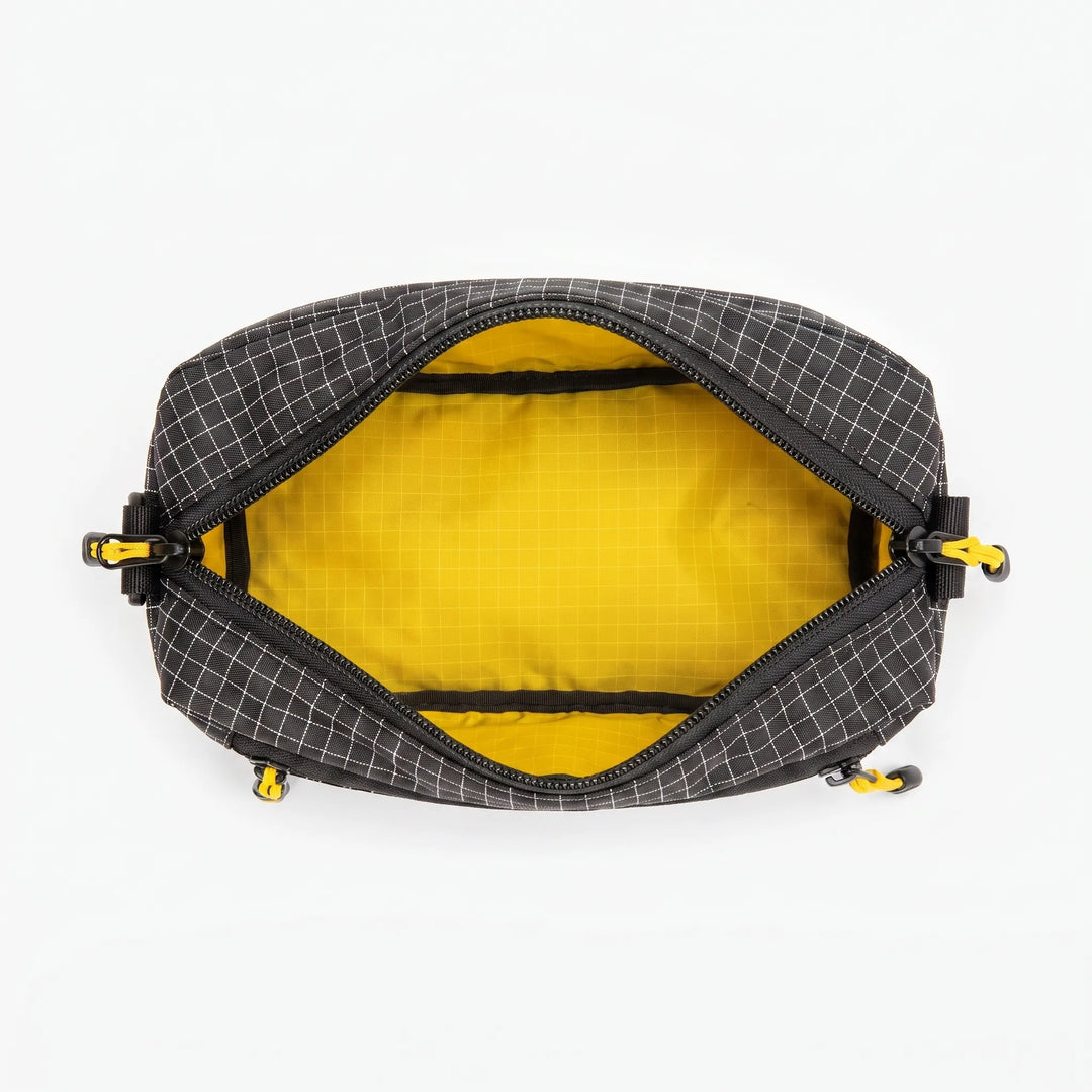 Spacious unisex grid fanny pack / chest bag for storing travel essentials, keys, and phone securely.