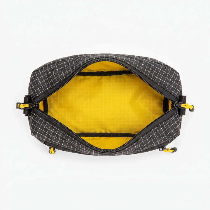 Spacious unisex grid fanny pack / chest bag for storing travel essentials, keys, and phone securely.