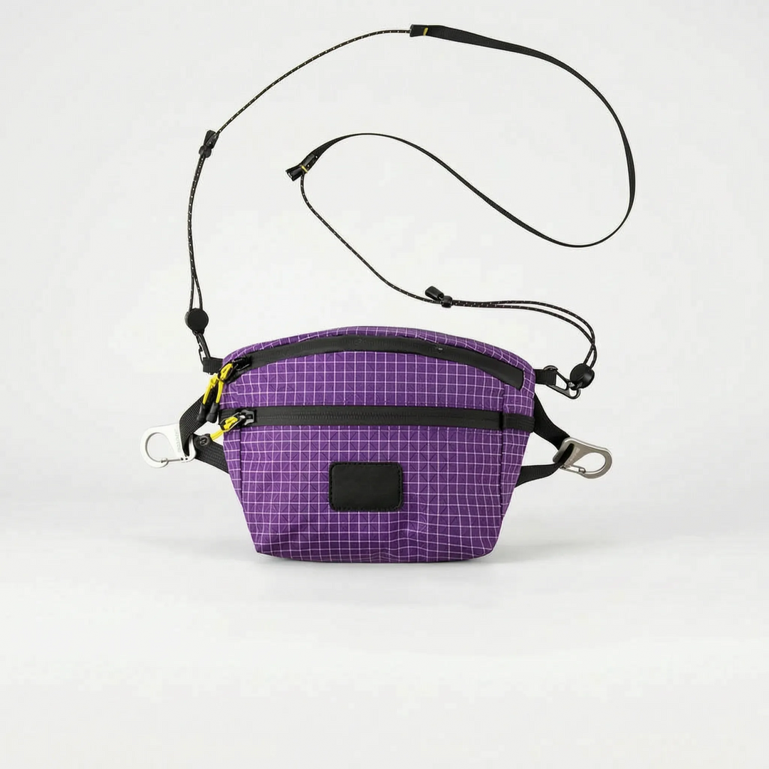 Flat lay of a stylish unisex grid pattern chest bag, a multifunctional travel and outdoor gear essential.