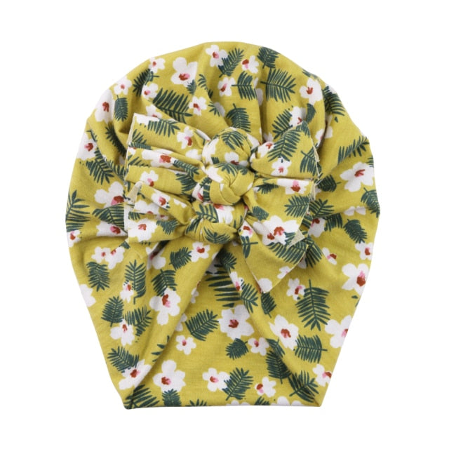 Delicate floral print baby beanie, soft and breathable for a newborn's head