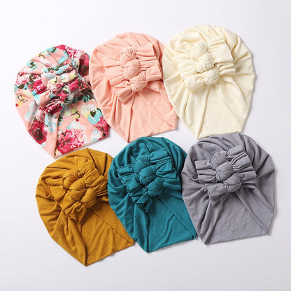 Close-up of a floral print baby beanie, perfect for newborn unisex infant headwear