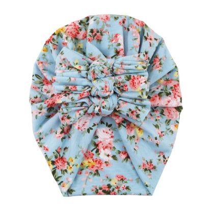 Close-up of the delicate floral print on a comfortable newborn baby beanie