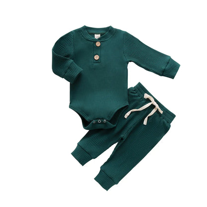 Detail of button closure on unisex newborn knit romper, cozy baby outfit