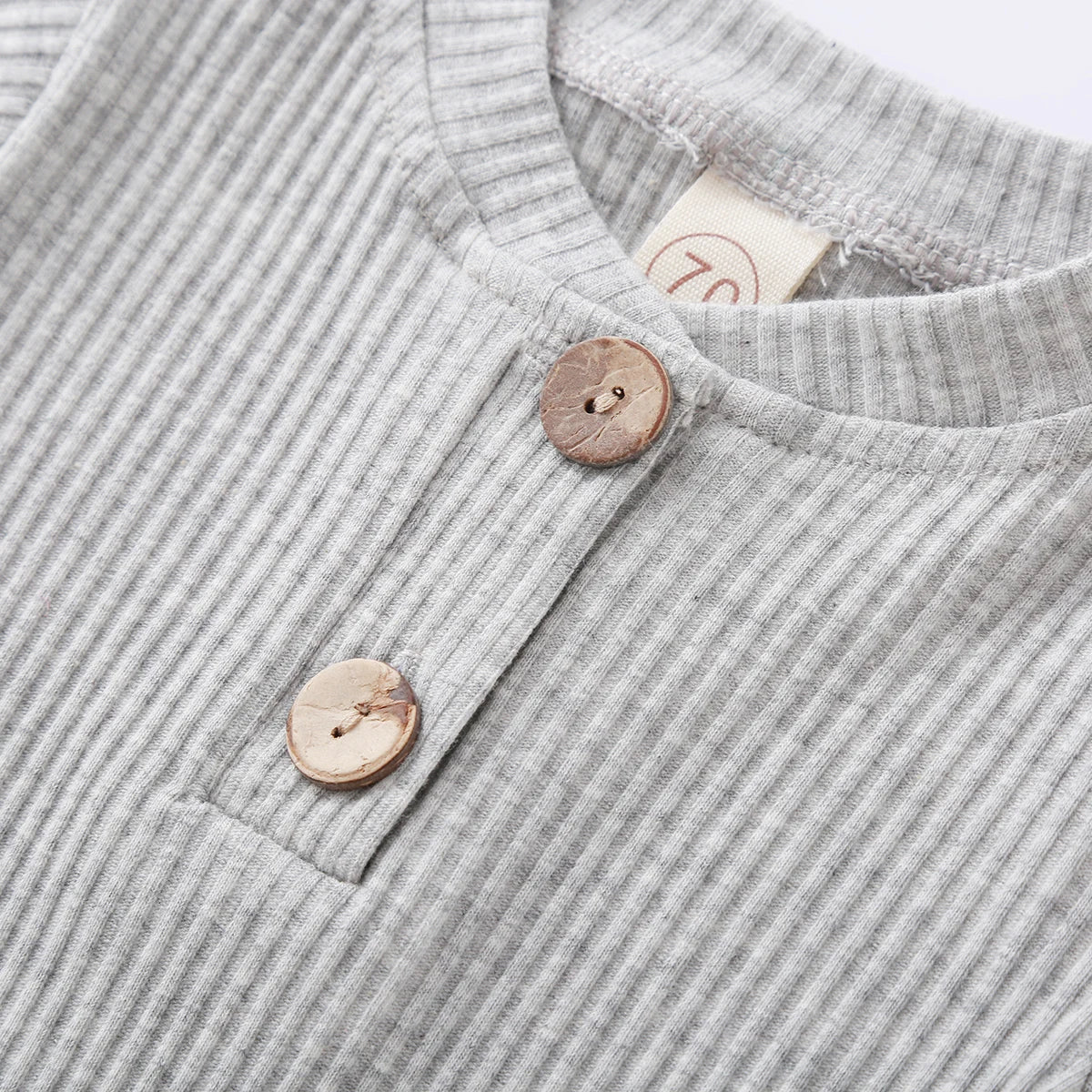 Close-up of knit fabric on a stylish newborn romper and pants set