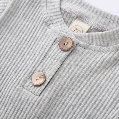 Close-up of knit fabric on a stylish newborn romper and pants set