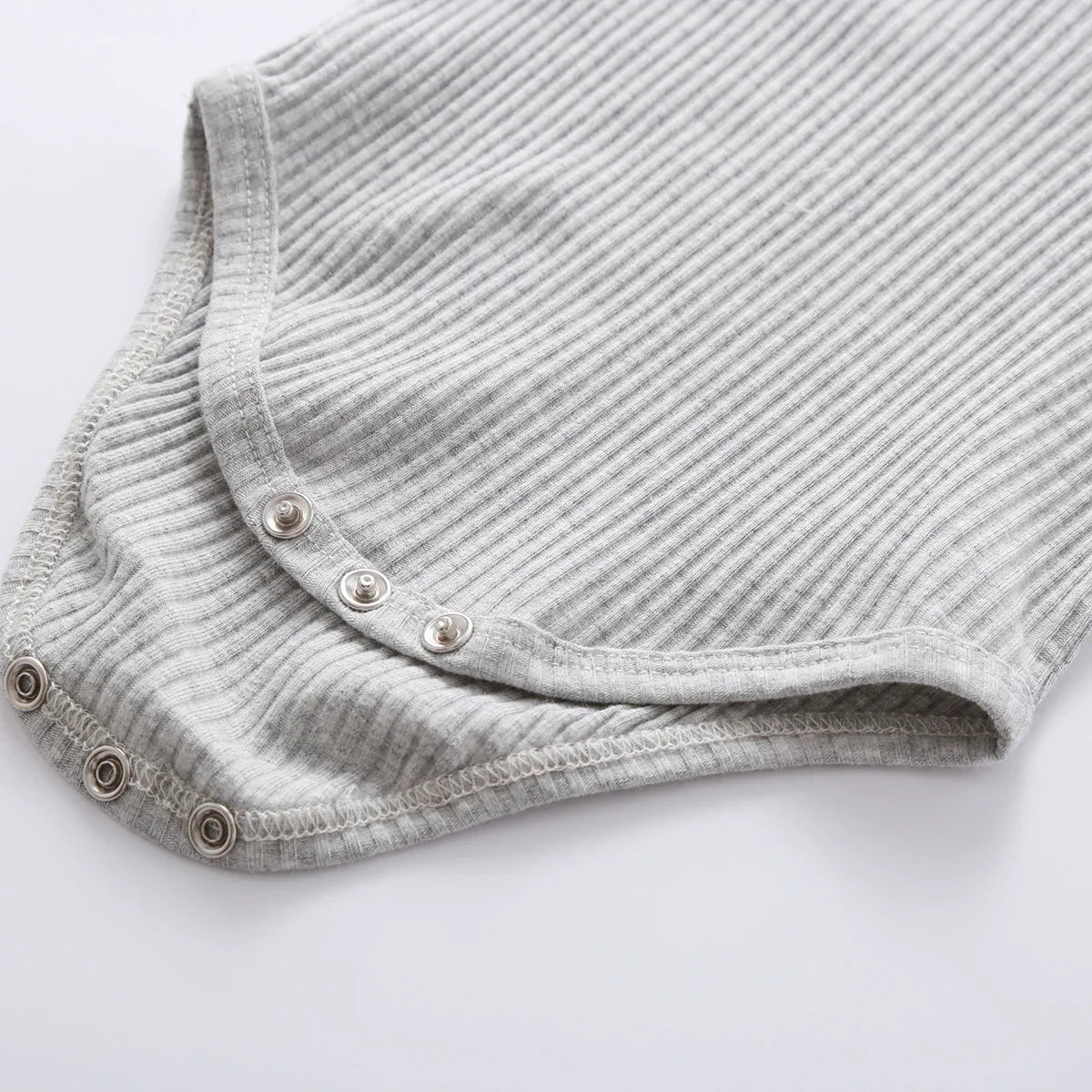 Unisex newborn knit outfit in a neutral color, long sleeve and pants included