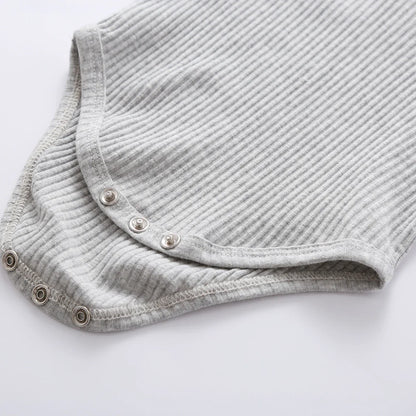 Unisex newborn knit outfit in a neutral color, long sleeve and pants included