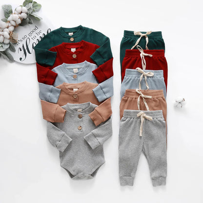 Close-up of knit texture on a unisex newborn romper and pants set