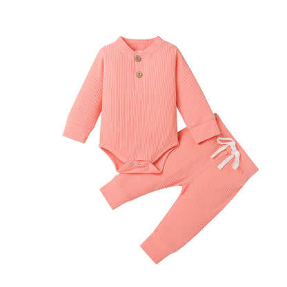 Newborn baby wearing a long-sleeve knit romper and accompanying pants, cozy