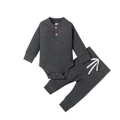 Cream colored knit two-piece set, long sleeve romper and pants for infant