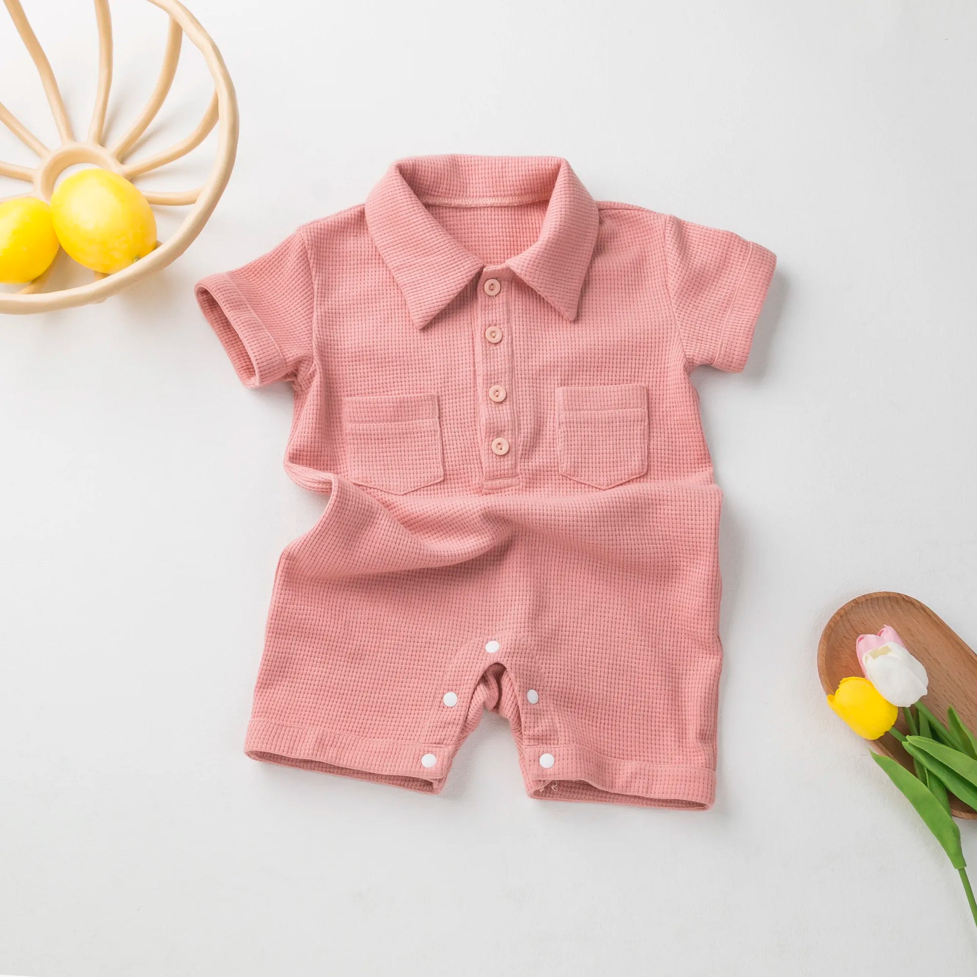 Unisex newborn short sleeve cotton jumpsuit with snap closures for easy changes.