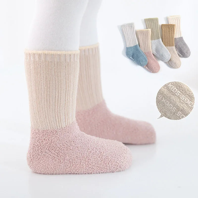 Close-up of a pair of non-slip infant winter socks for newborns, plush interior
