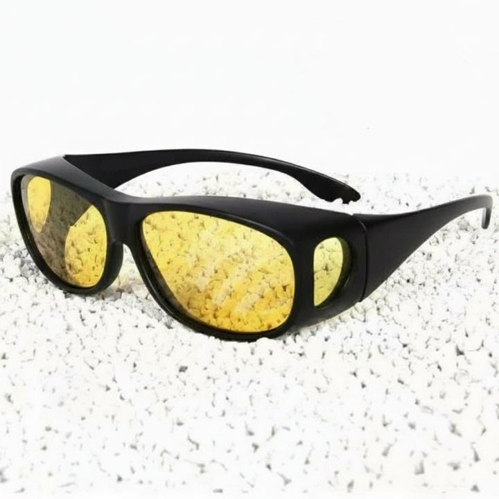 Driver wearing unisex night vision glasses, enhancing road visibility and reducing glare in low light.