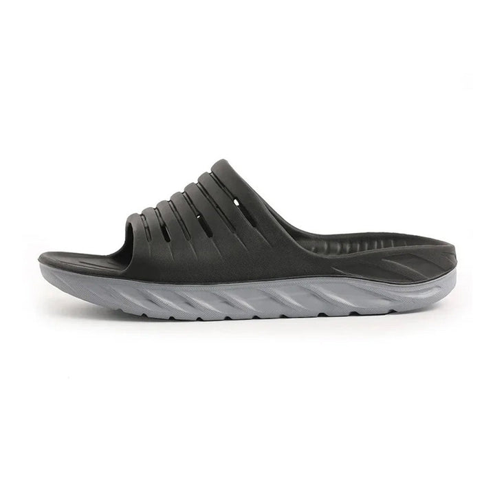 Unisex orthopedic arch support slides for foot pain relief, ideal for plantar fasciitis & heel pain recovery.