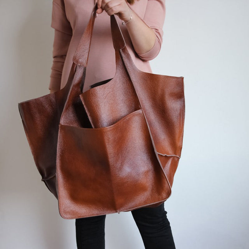 Side view of a practical unisex oversized duffel bag. Durable travel bag for all your weekend needs.