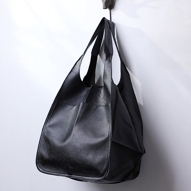 Detail of durable straps on a unisex oversized duffel bag. A reliable large capacity weekender.
