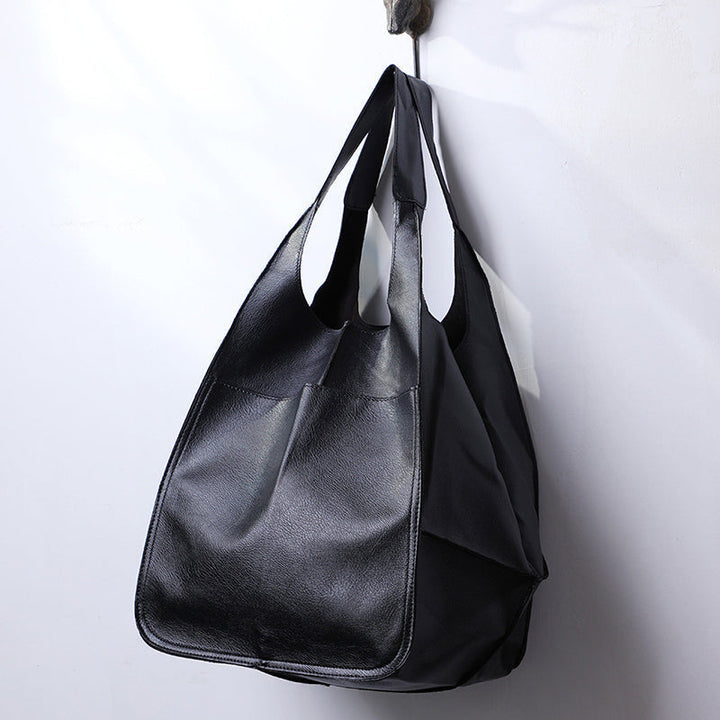 Detail of durable straps on a unisex oversized duffel bag. A reliable large capacity weekender.