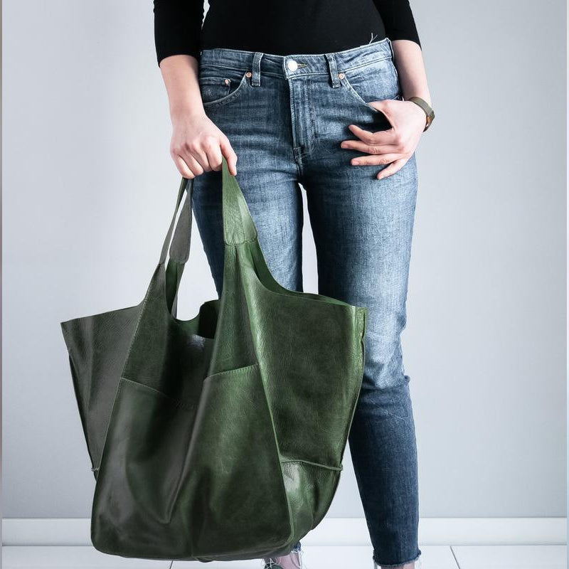Front view of a chic unisex oversized travel duffel. Perfect carry-on weekender with large capacity.