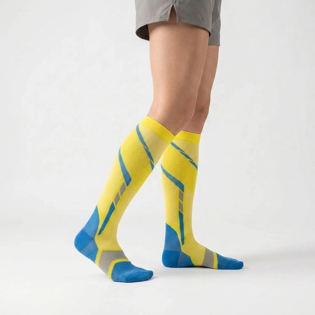 White unisex knee-high running socks, providing active support & compression for workouts & long runs.