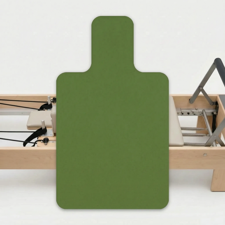 Essential Pilates studio equipment: a stable non-slip reformer pad for enhanced safety & clean exercise.