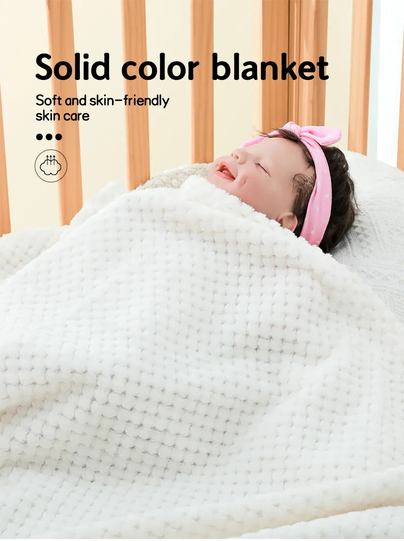 Baby wrapped in a soft pineapple plaid blanket, peaceful and comfortable