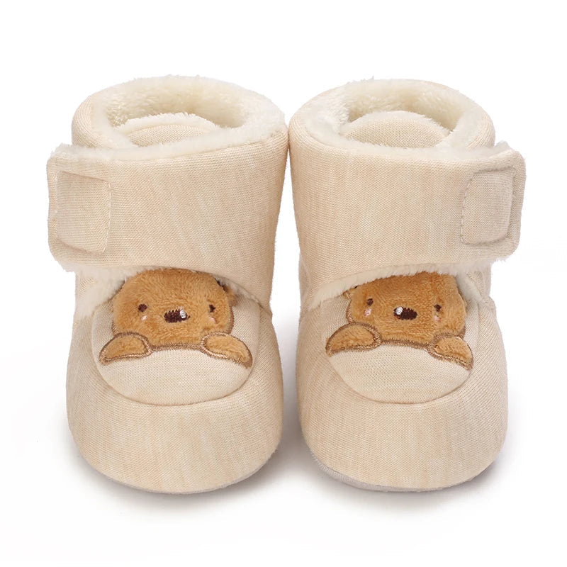 Unisex bear booties displayed on a clean surface, ready for a baby's first steps