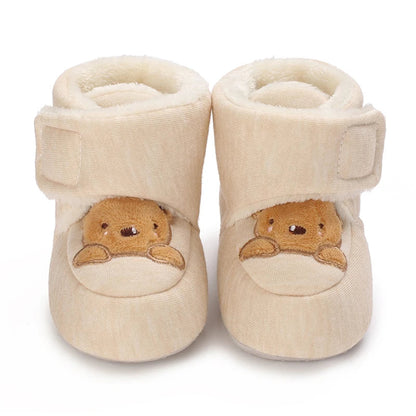 Unisex bear booties displayed on a clean surface, ready for a baby's first steps
