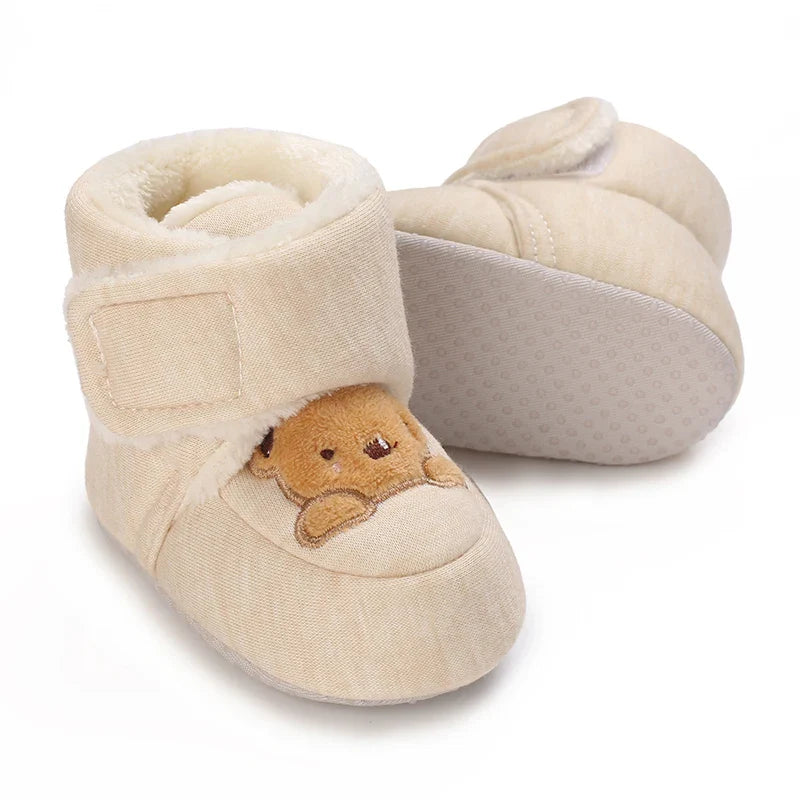 Close-up of a single plush bear baby bootie, soft sole infant shoe with hook and loop closure