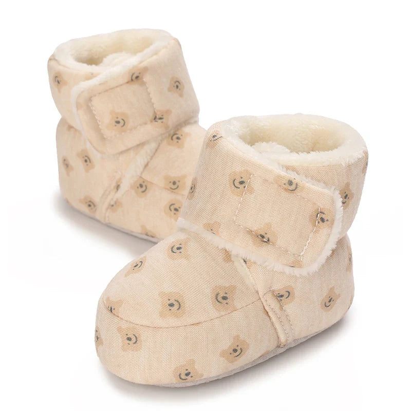 Baby wearing plush bear booties, comfortable and warm infant footwear for winter