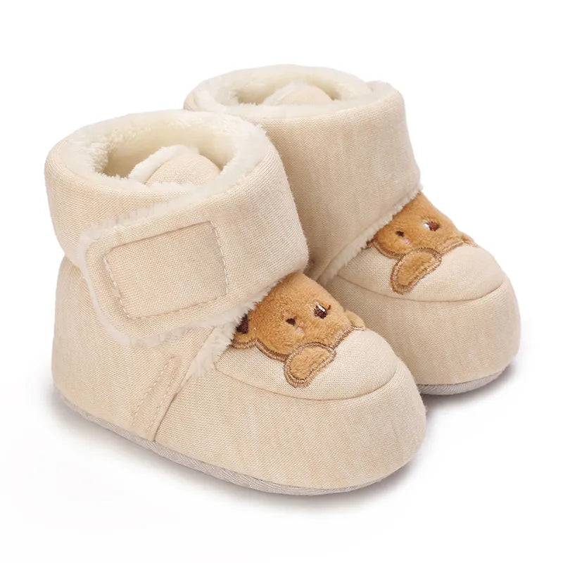 Side view of infant footwear, unisex bear design booties with soft, flexible sole