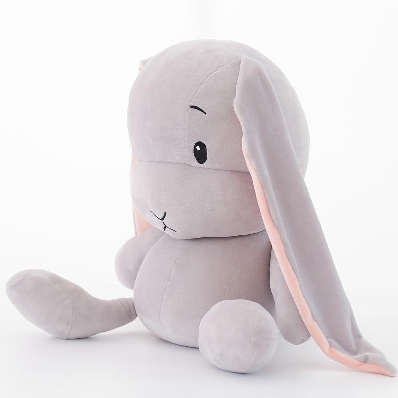 Full view of a white plush bunny toy, ideal unisex stuffed animal for children's bedroom.
