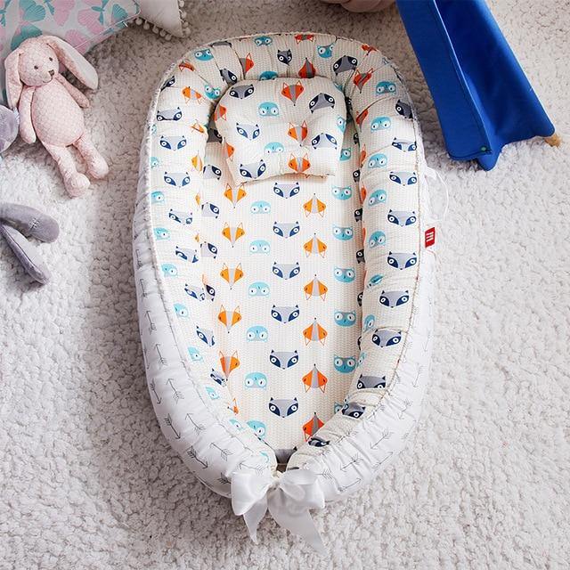Grey portable snuggle nest for babies, a comforting infant bed for home and travel, baby gift idea