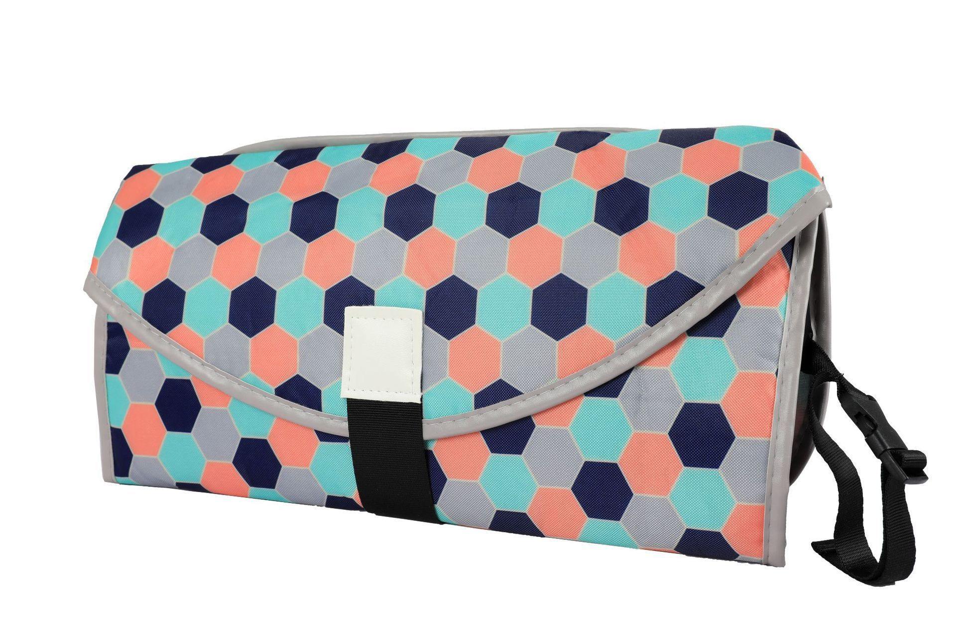 Unisex portable changing pad and clutch, shown with diapers and wipes, ready for travel. View 5.