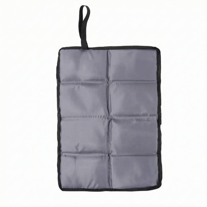 Ultralight portable camping seat pad in hand, perfect foldable cushion for outdoor adventures & travel.