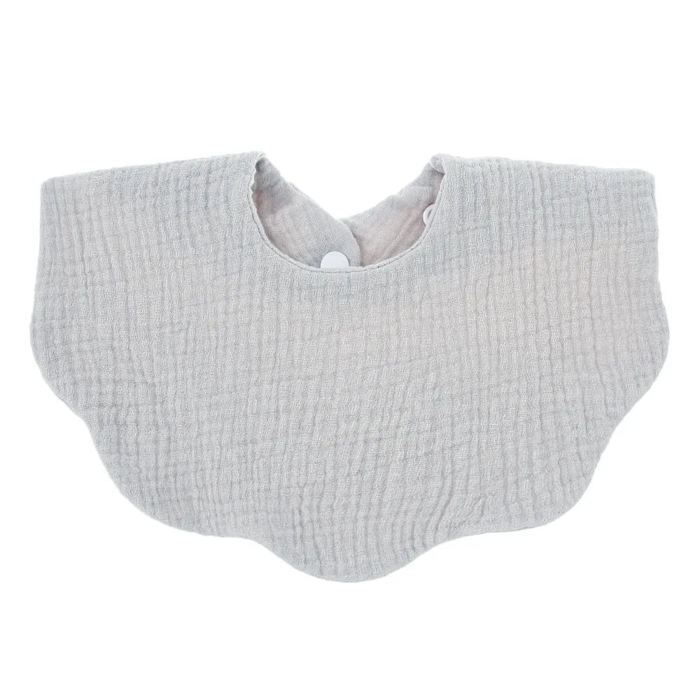 Close-up of the ultra-soft fabric of a unisex cotton baby bib, highlighting comfort for newborn skin