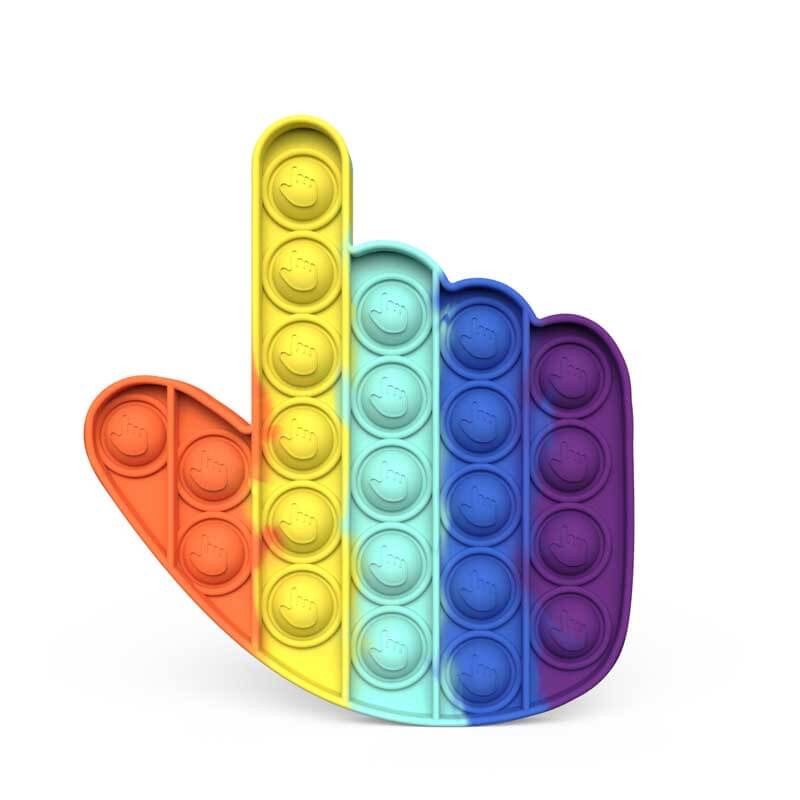 Child smiling while playing with a large, colorful push pop fidget toy, sensory stimulation