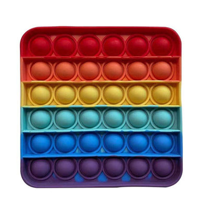 Adult's fingers engaging with a green hexagonal push pop fidget toy, stress & anxiety relief