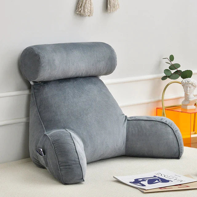 Unisex reading bed pillow with arms, providing ergonomic back & neck support for ultimate lounging comfort.