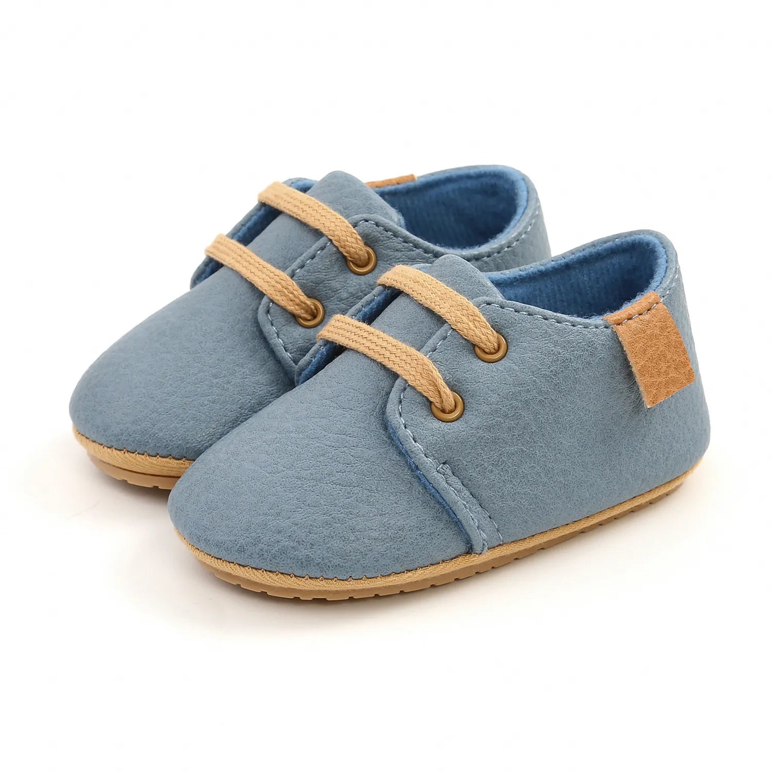 Pair of unisex tan toddler moccasins, soft sole for comfortable movement